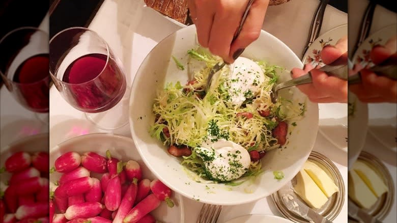A diner enjoys a salad at Chez Georges