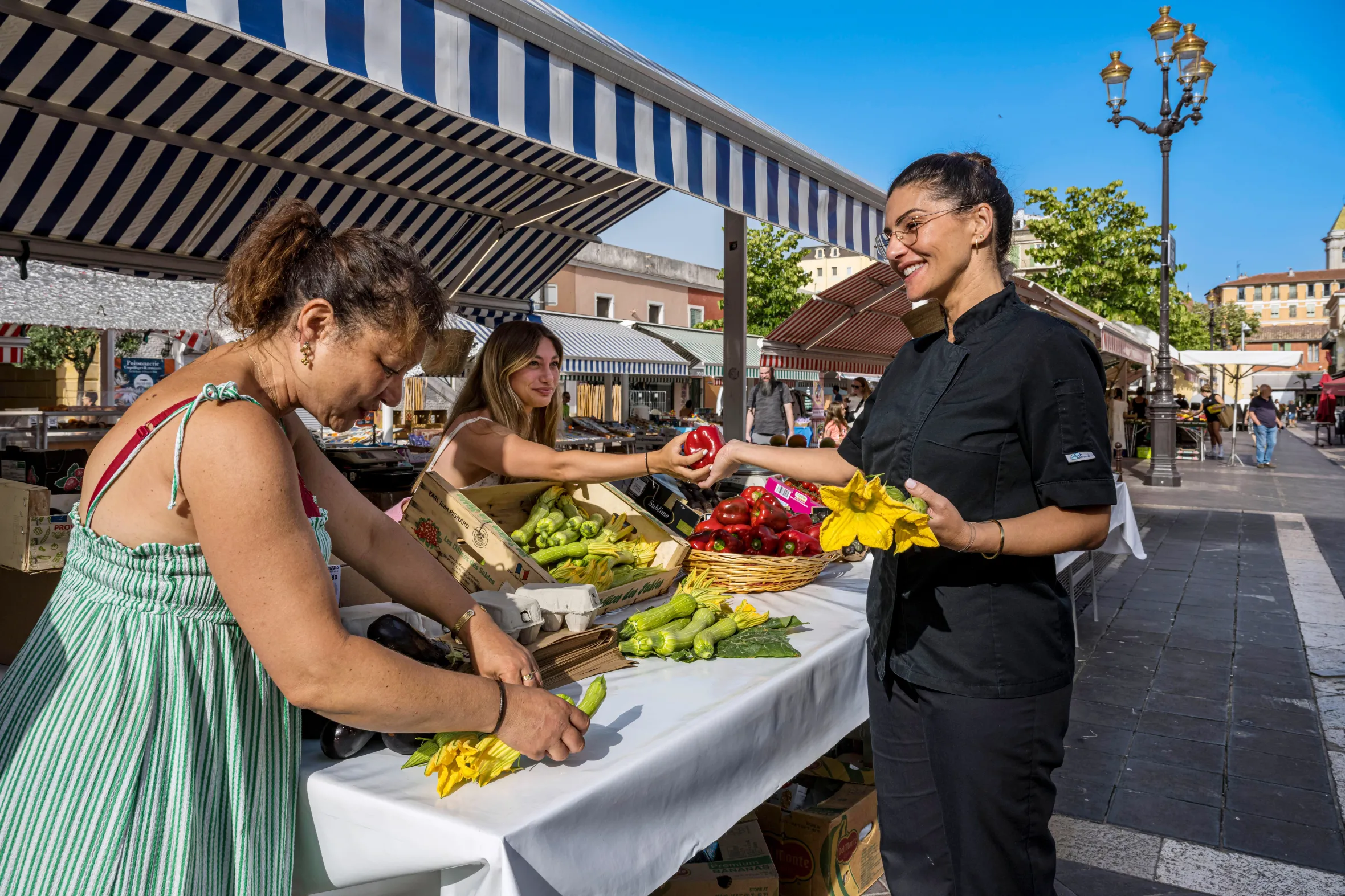 The chef of the restaurant Acchiardo buying courgette flowers at the market in Old Nice. Acchiardo is one of the best restaurants in Nice