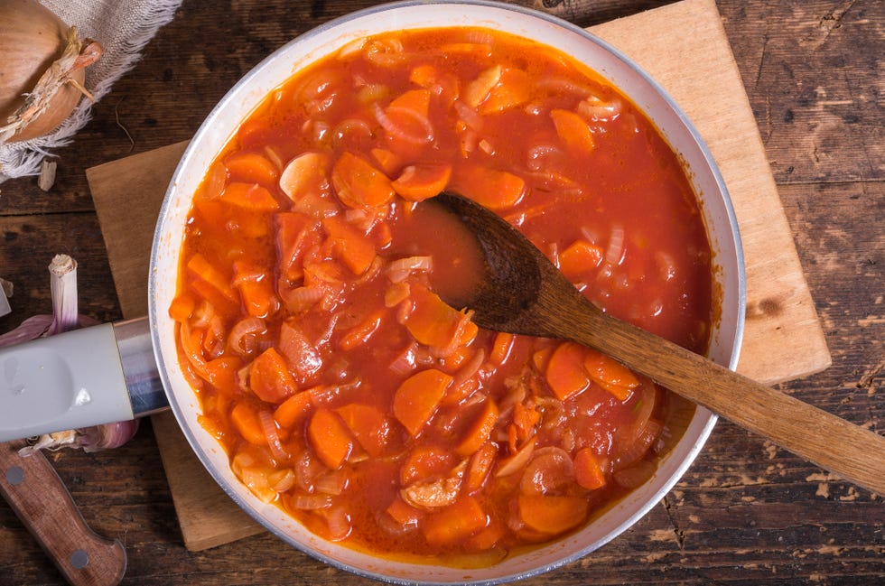onions, carrots, garlic and tomatoes in a pan