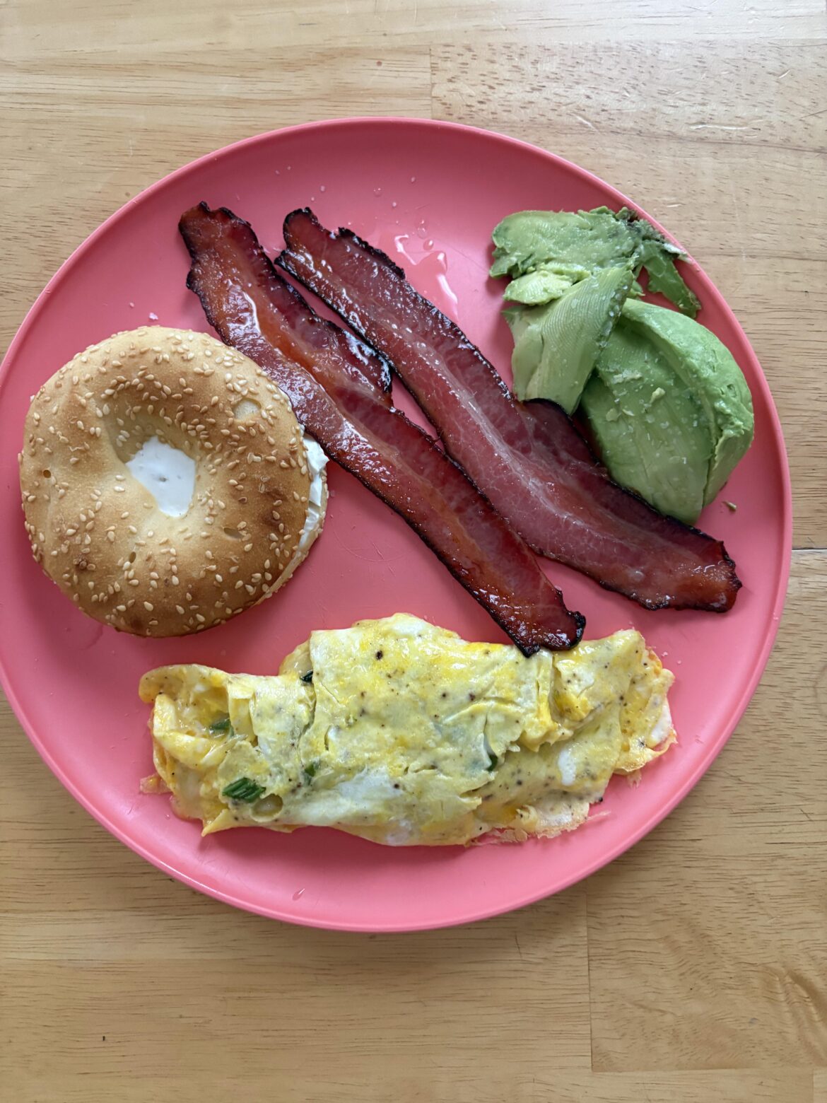 Bagel with cream cheese, bacon, avocado, omelette with cheddar and green onion