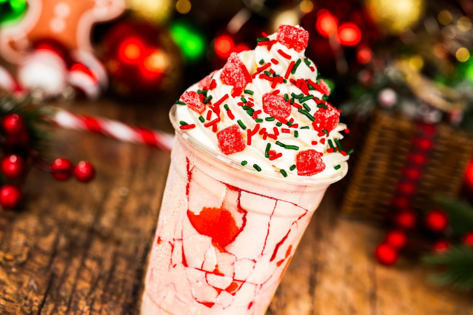 Cherry-White Chocolate Slushy: Fanta Cherry served with a crackable white chocolate-coated cup with whipped cream, cherry gummy candy, and festive sprinkles at Mickey’s Very Merry Christmas Party 2025