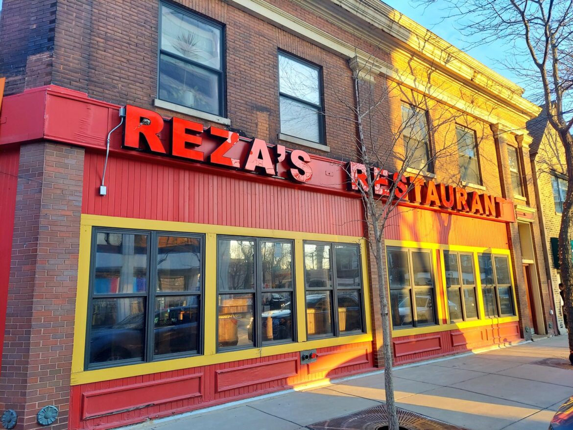 An Evanston storefront with “Reza’s Restaurant” spelled out in large red lettering.