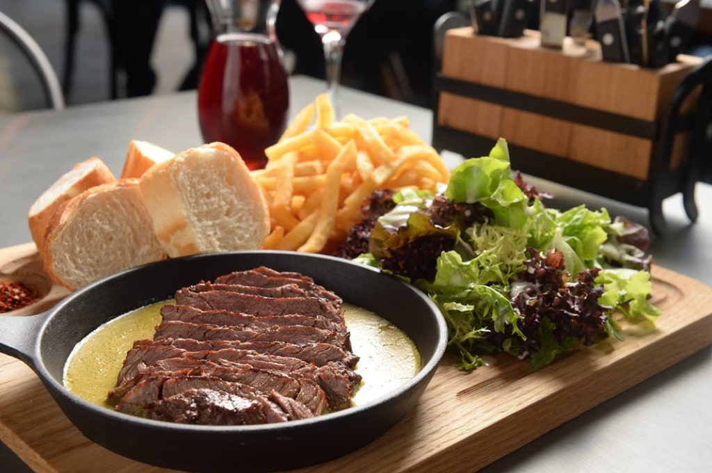 beef in skillet with chips and salad