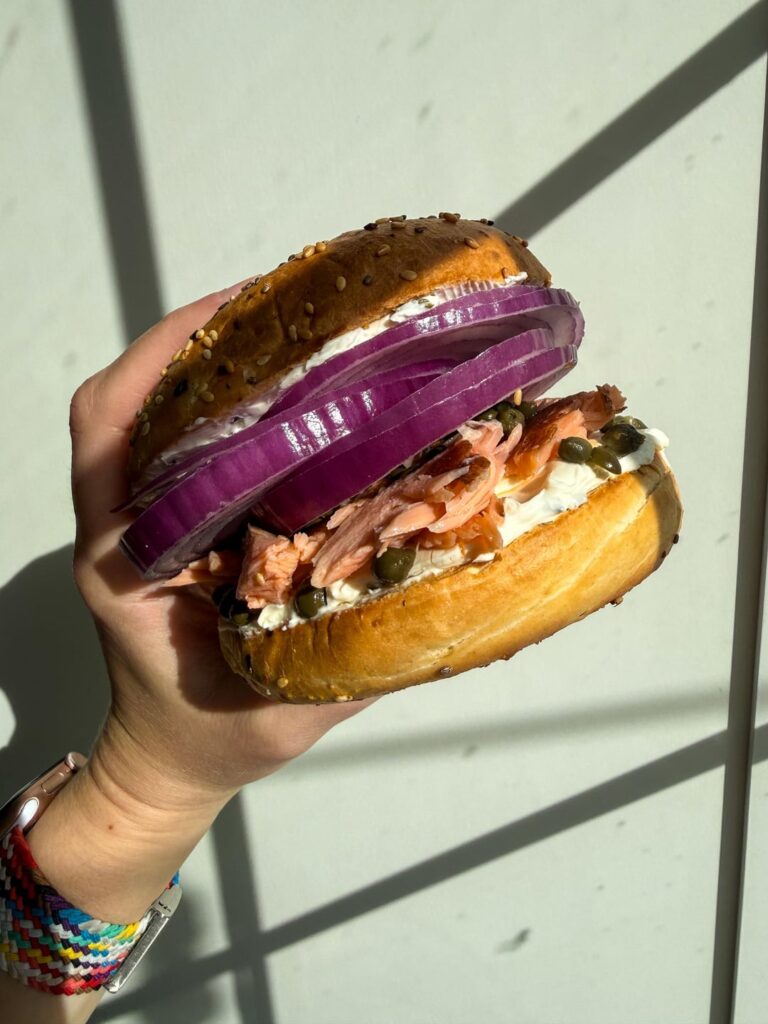 Smoked salmon bagel with red onion, onion and chive cream cheese, and capers