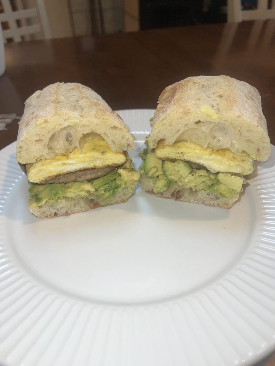 Cheese omelet, sausage and avocado on ciabatta baguette.