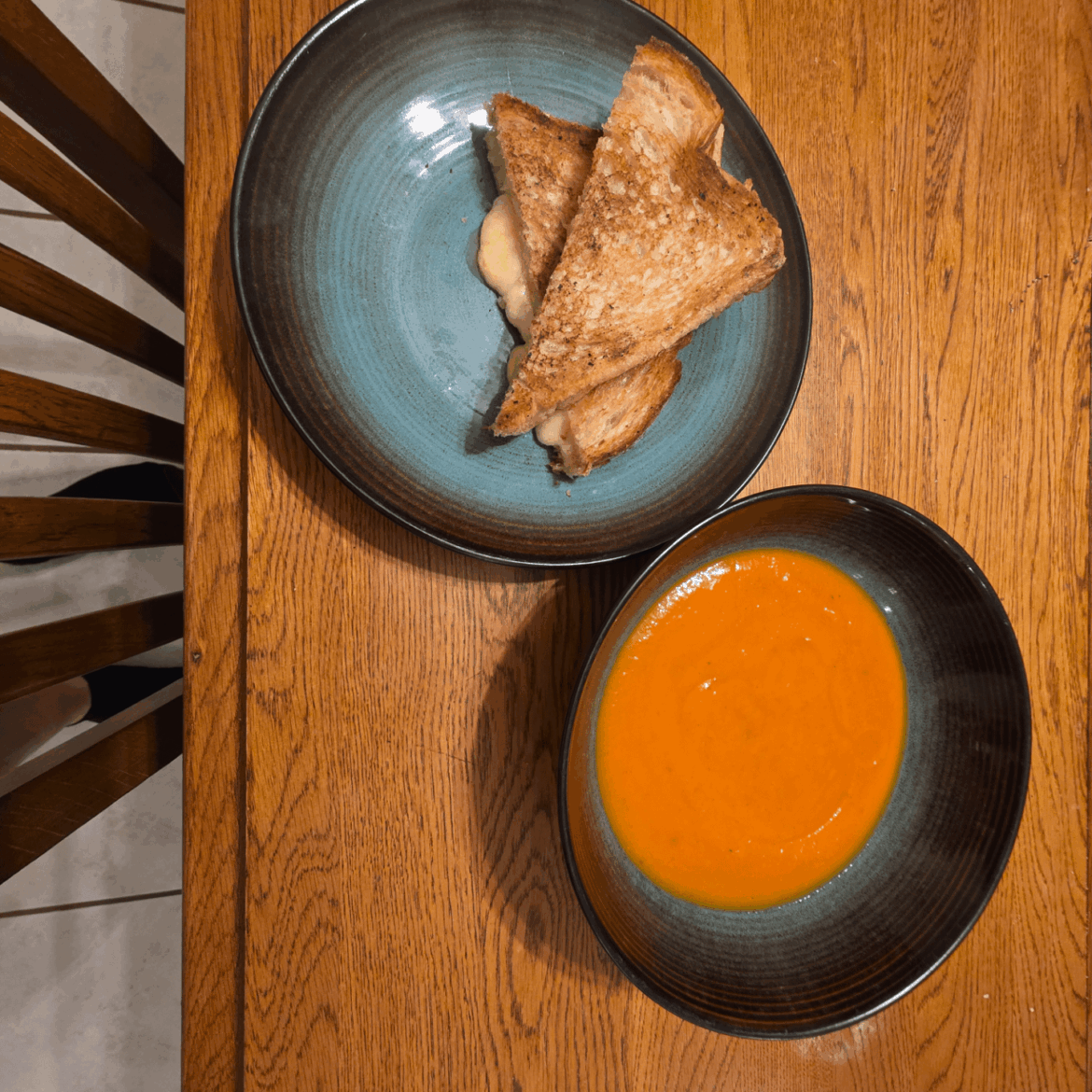 Grilled cheese with aged white Tillamook cheddar between Swiss slices on Sourdough, with Butternut/Tomato soup