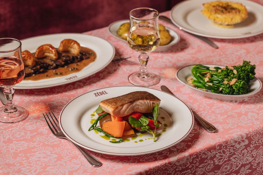 dishes of fish and veg on table with pink tablecloth