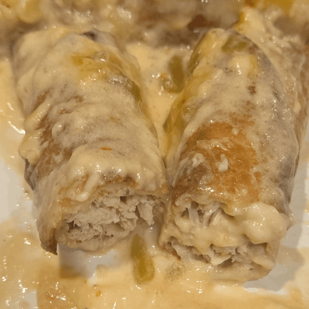 Chicken flautas baked in creamy enchilada sauce