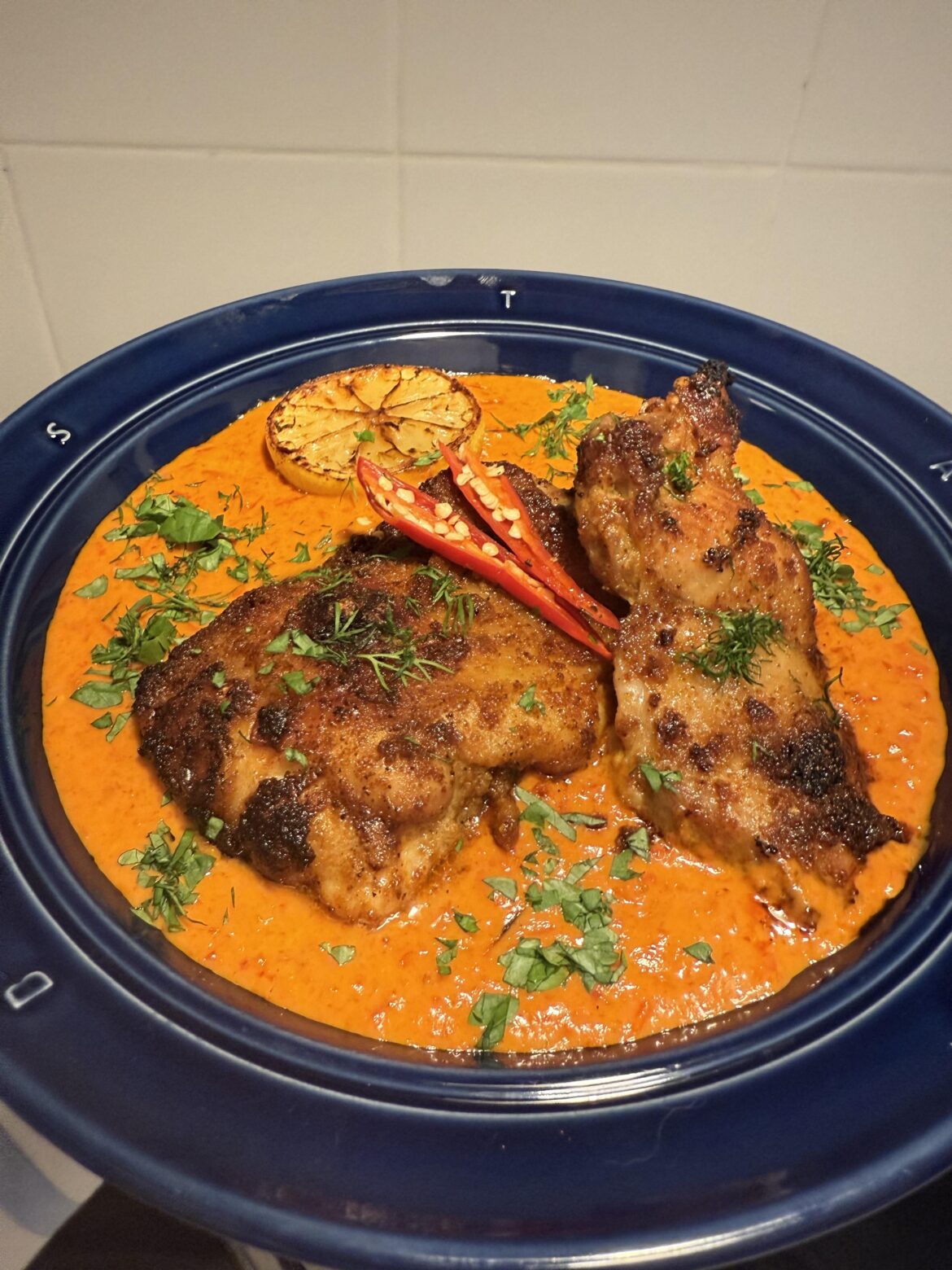 Smokey Paprika & Cayenne chicken with Mojo Rojo sauce, charred lemon, and extra chilli for good measure