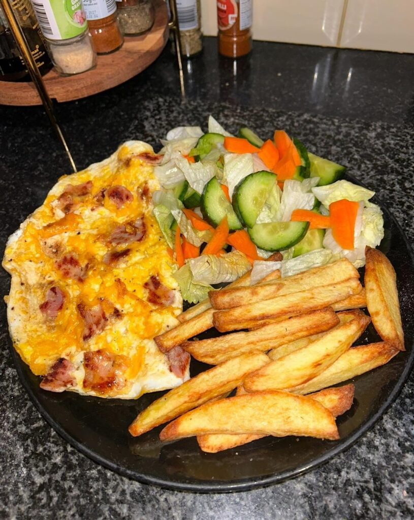 Bacon & cheese omelette, chips and salad - 525 cal, 36g protein.