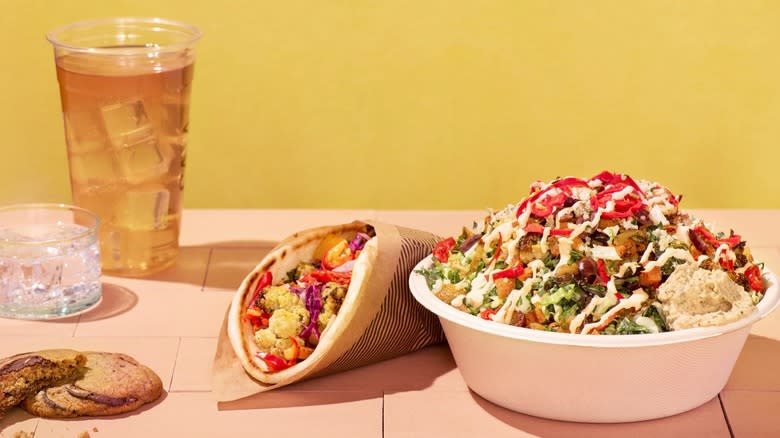 A drink, cookie, pita wrap, and vegetable bowl from Cava