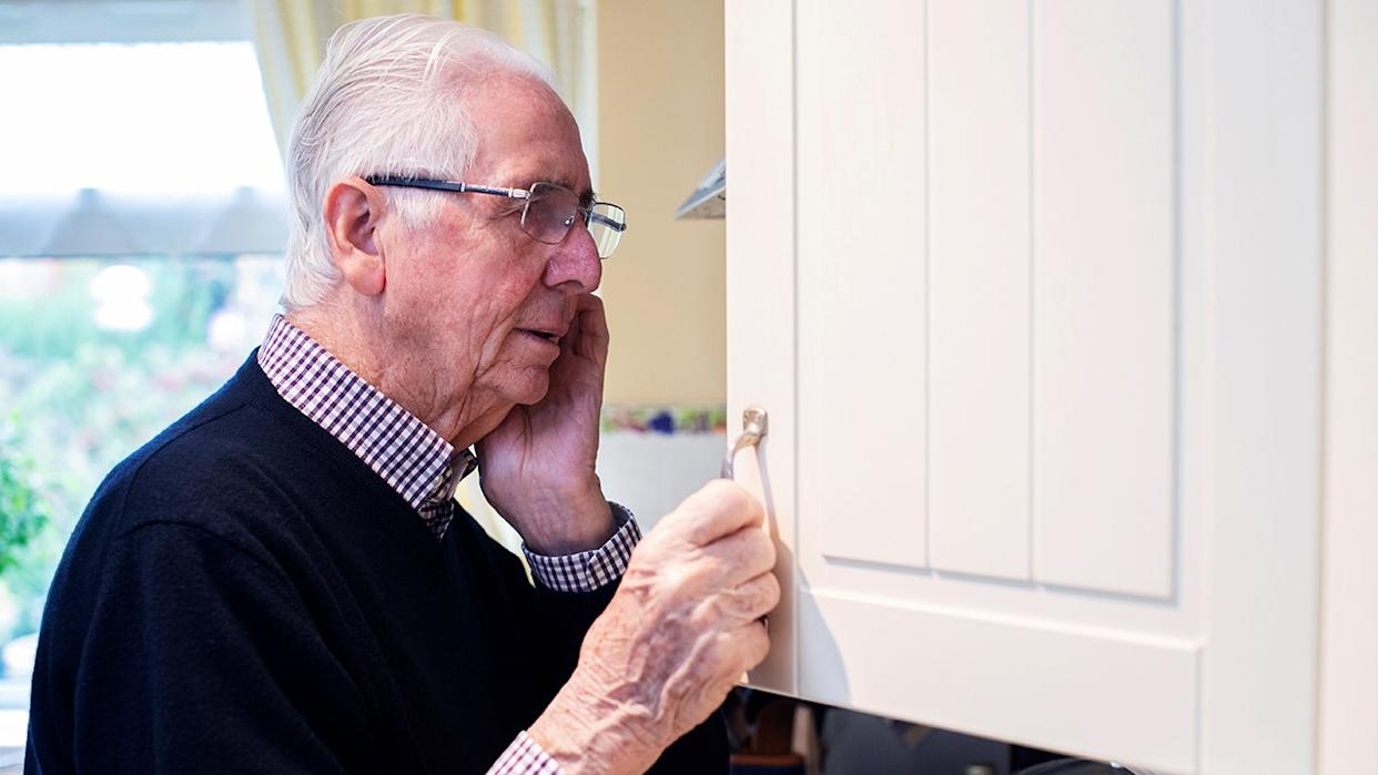 Old man looking into pantry