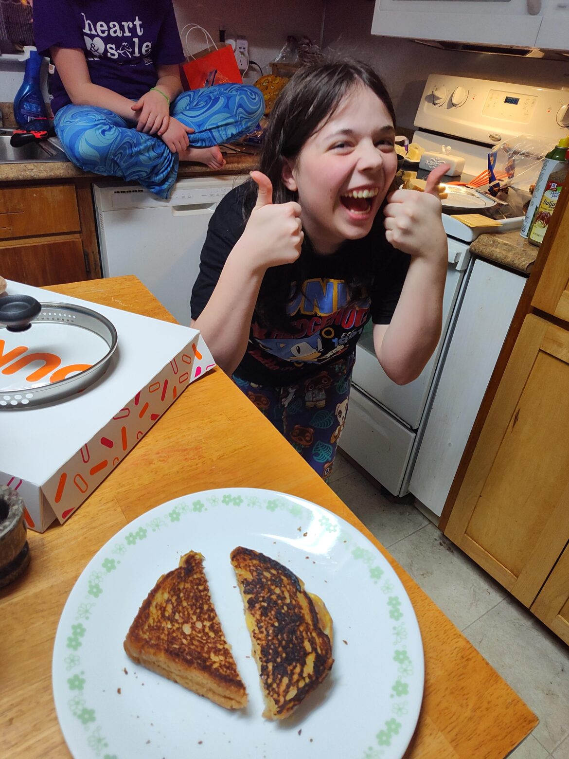 Gotta start'em young. Her first grilled cheese.