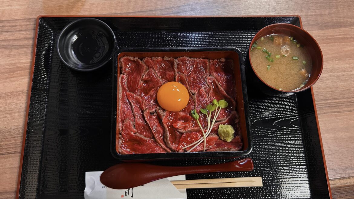 [i ate] rare steak served on warm white rice with an egg yolk