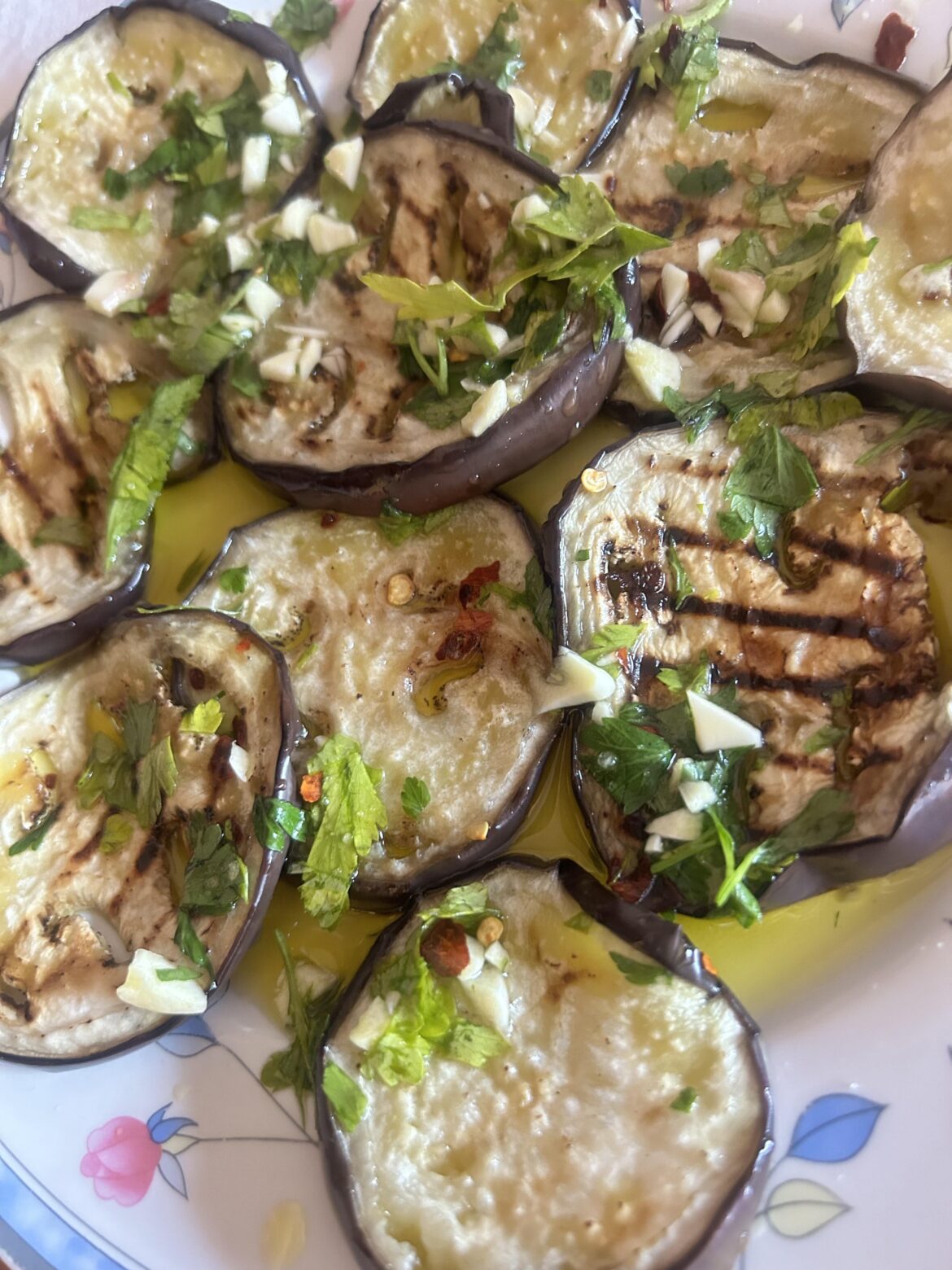 Grilled aubergines with a brine of oil, garlic, and chilli pepper.