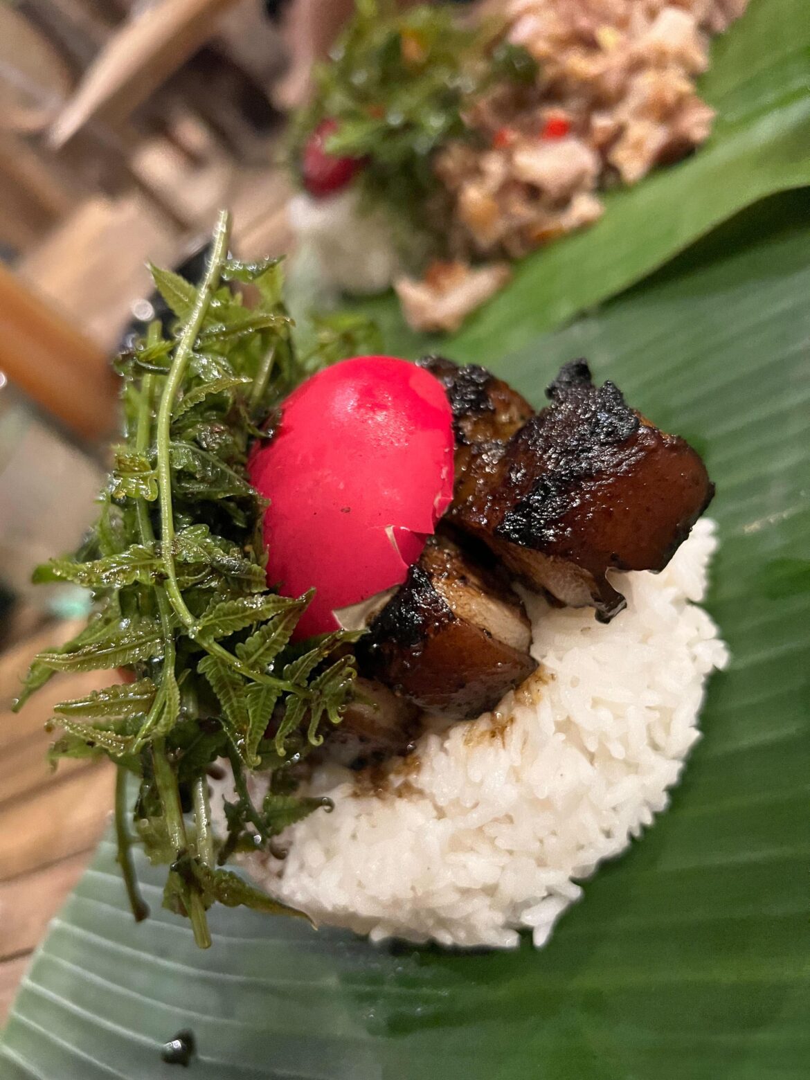 Grilled pork belly with salted egg and fern salad with rice