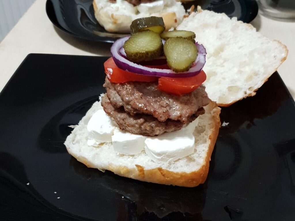 Burgers with ciabatta, flattened mici, goat cheese, tomatoes, red onions, pickles, garlic cream. And one with melted kashkaval.