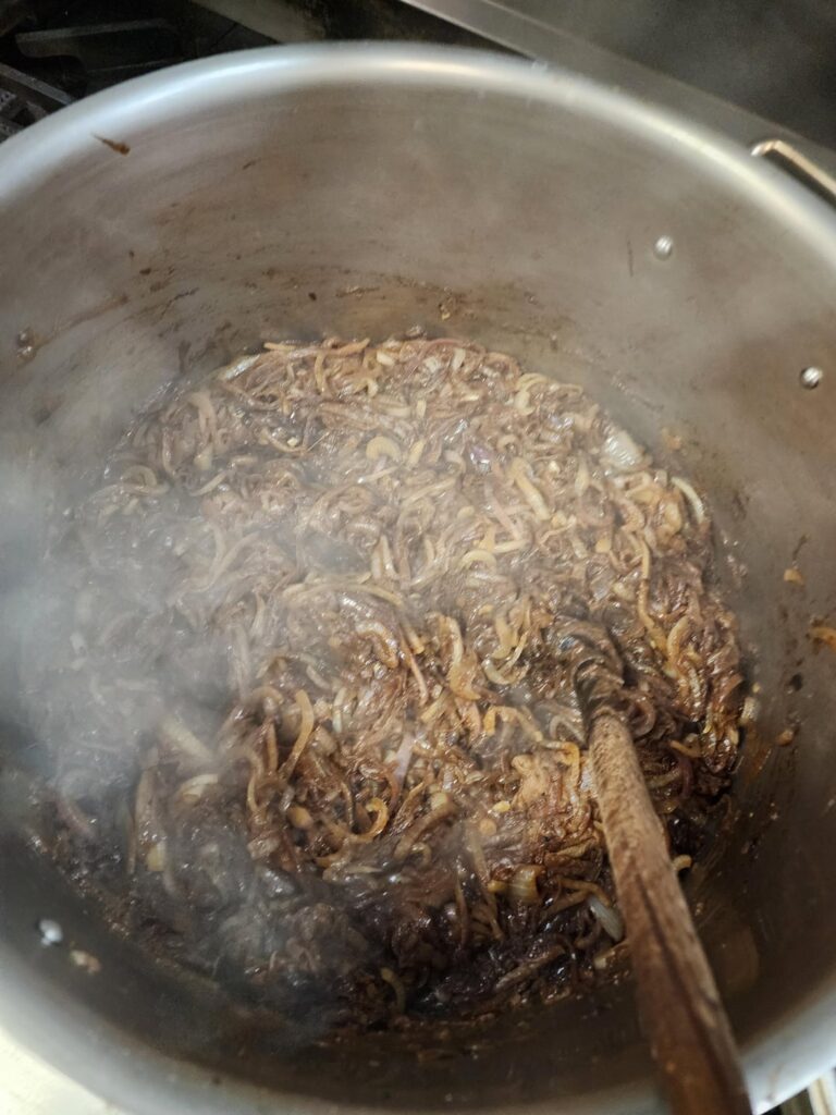 About 7.5 gallons of red/white onions being caramelized for French onion soup!