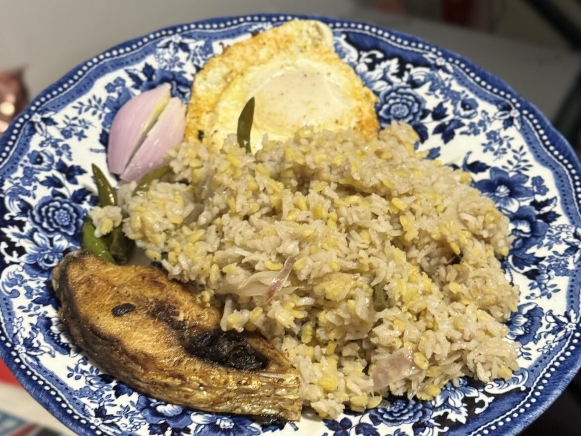 Hilsha Fish, Rice with Lentil (Khichuri), Fried Egg, and Onion on the side.