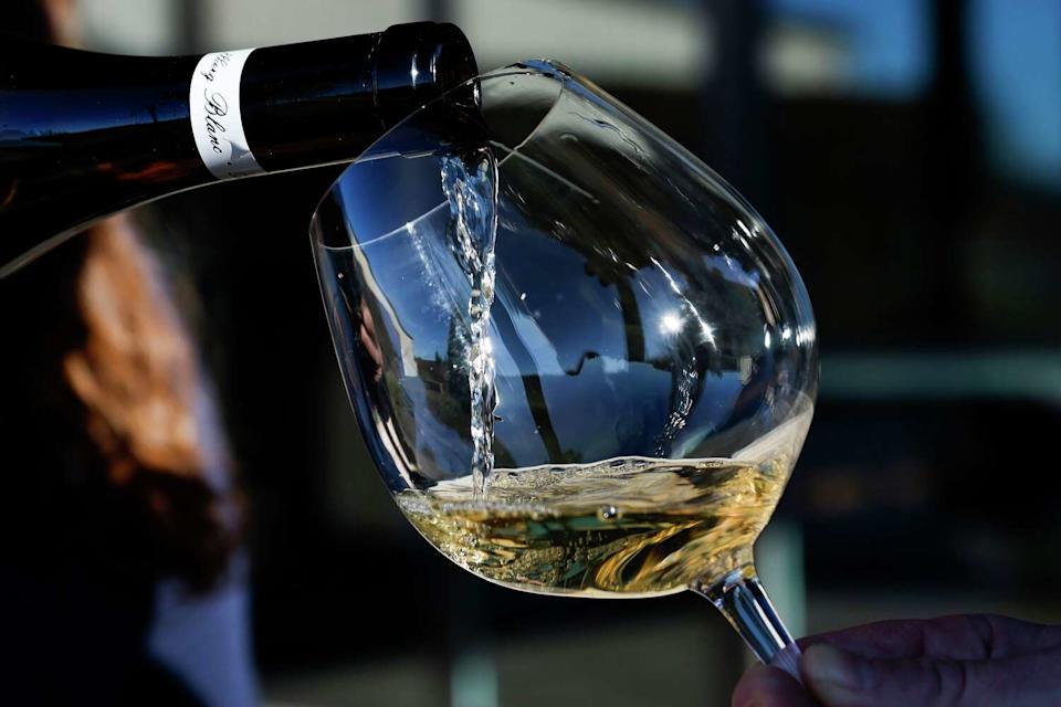 The average price of a bottle of American wine shipped directly from U.S. wineries rose 11% in 2025, according to a new wine industry report, but sales and value experienced record declines. Wine is poured at a the Emeritus Vineyards tasting room in Sebastopol in 2024. (Jessica Christian/The Chronicle)