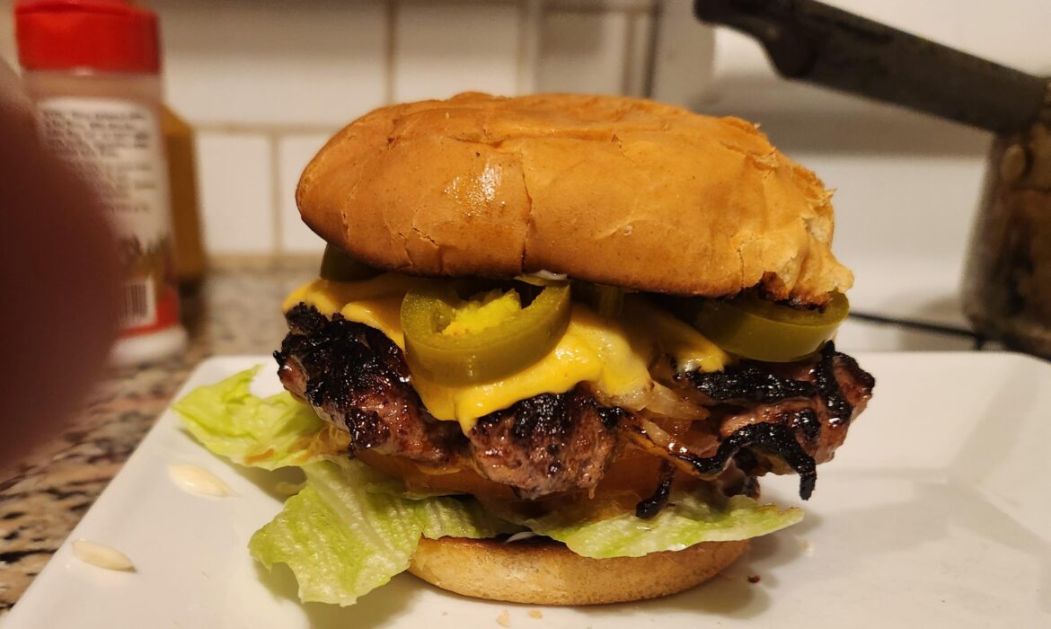 Oklahoma onion Burger w lettuce, tomato, Jalapeños, Duke's mayo & Duke's mustard on a toasted bun. Made by a real live Okie!