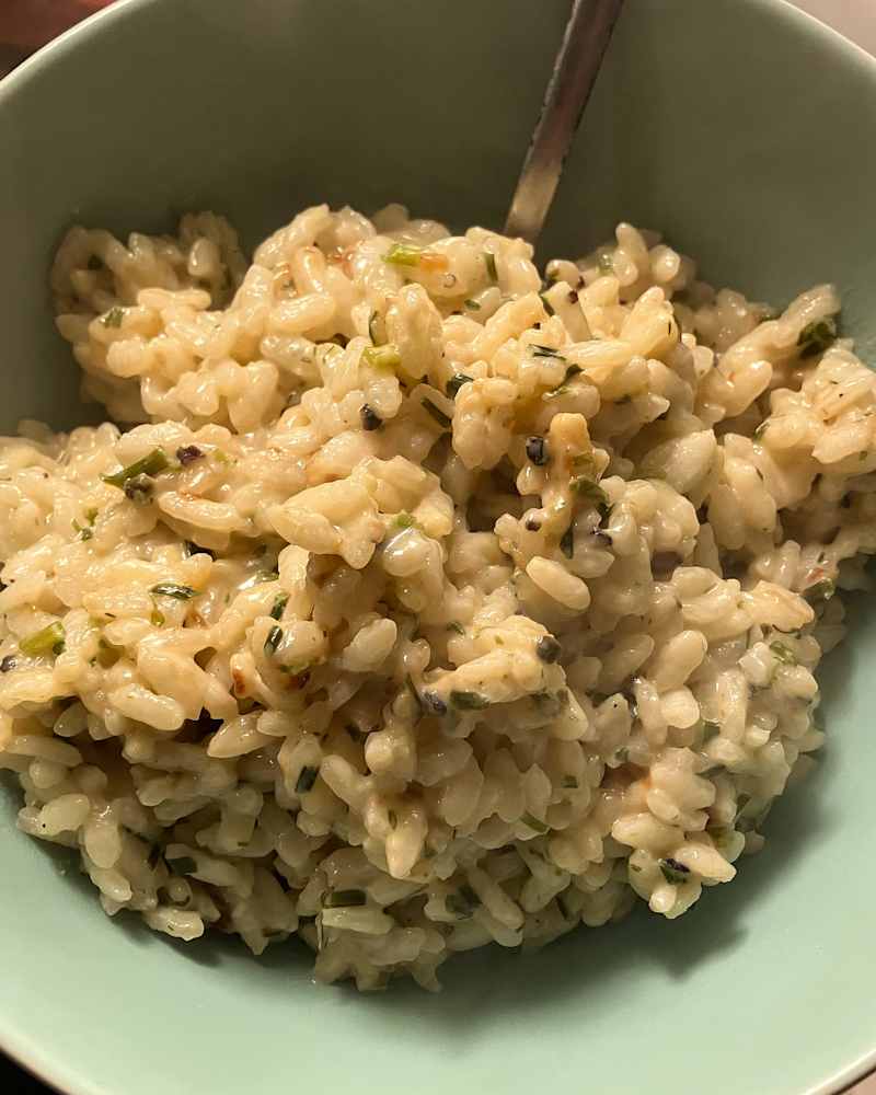 Black pepper and goat cheese risotto in bowl.