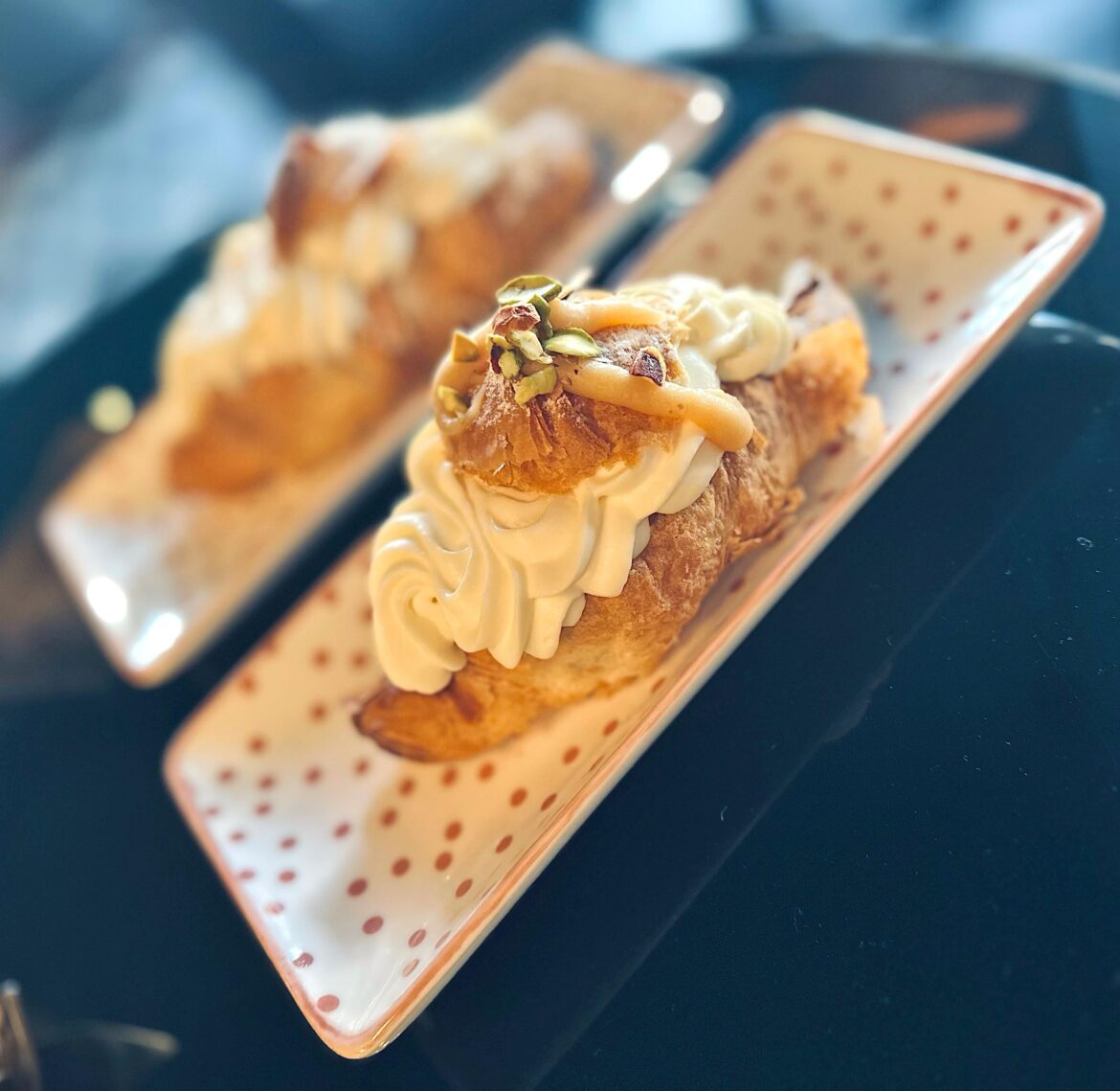 Croissant filled with caramel sauce and topped with cream cheese