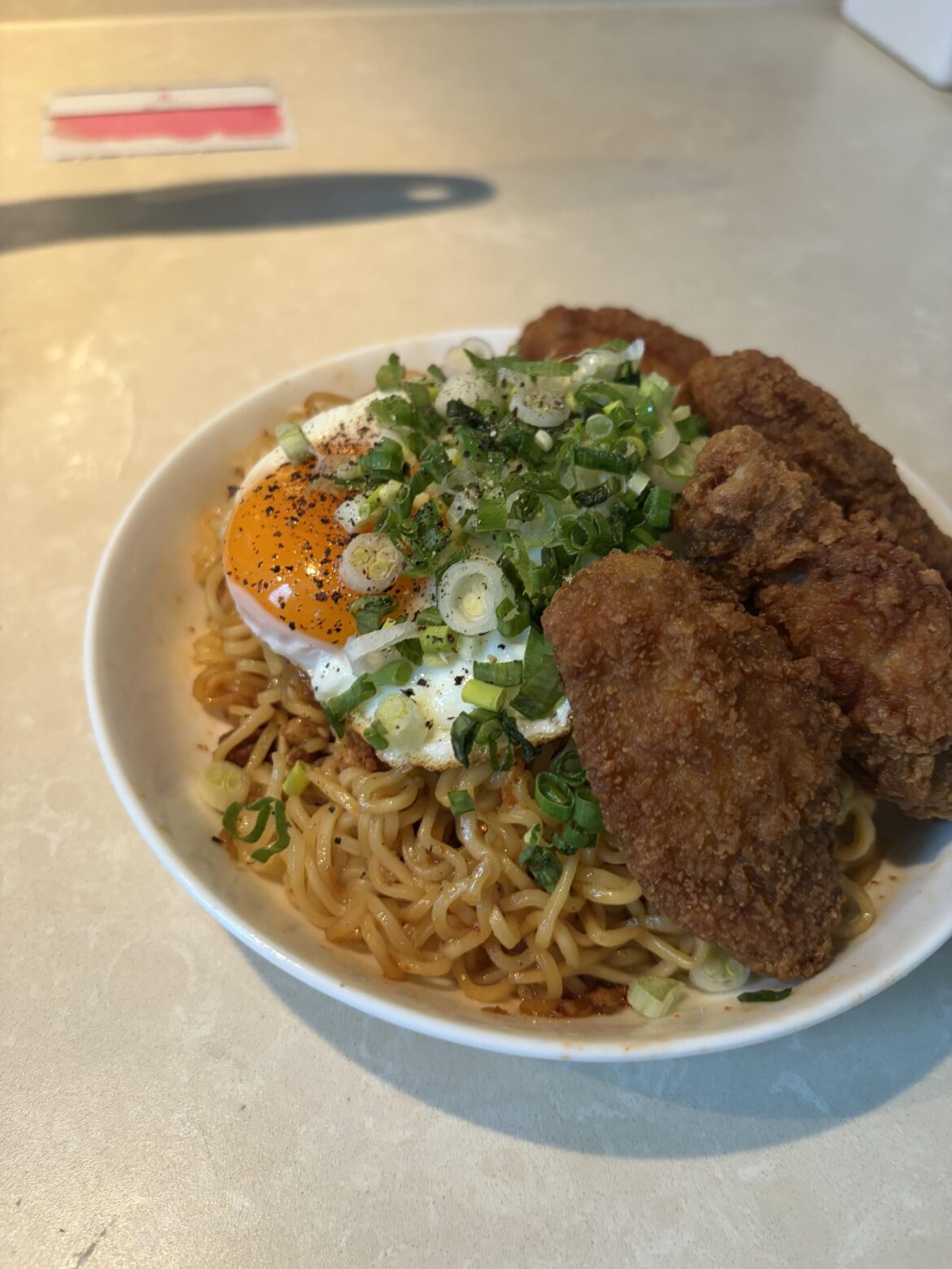 I placed an egg on my instant noodle. Topped with green onion and served with fried chicken. 😮‍💨👌