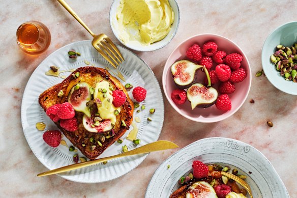 Serve the French toast with the whipped butter, fresh raspberries and figs, pistachios, plus an extra drizzle of honey.