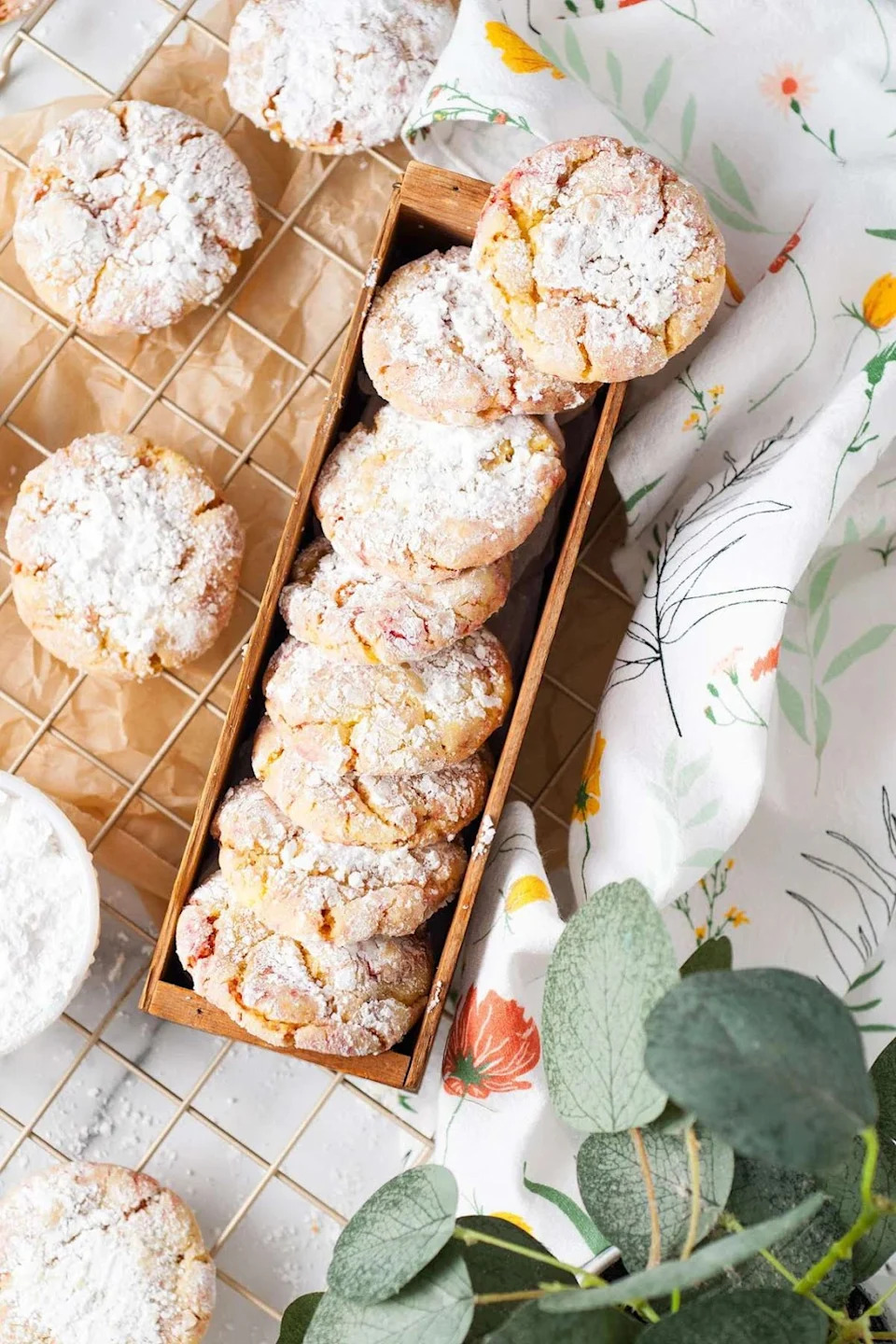 Strawberry lemon cake mix cookies in a box and on a cooling rack.