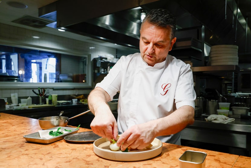 Chef Bruno Davaillon plates the hot honey crispy duck breast dish at Georgie, Monday, Feb....