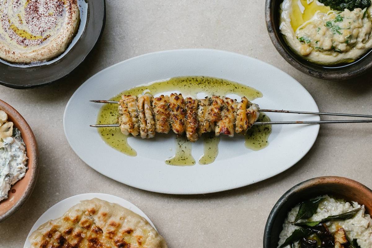 an array of greek dishes presented on a table