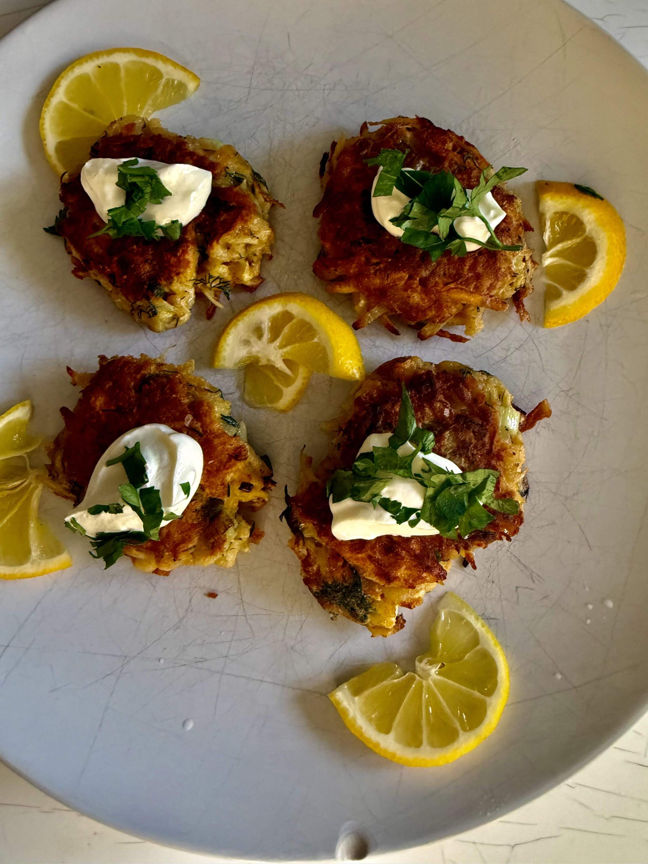 Parsnip and dill pancakes with sour cream topping. (Kathy Gunst/Here & Now)