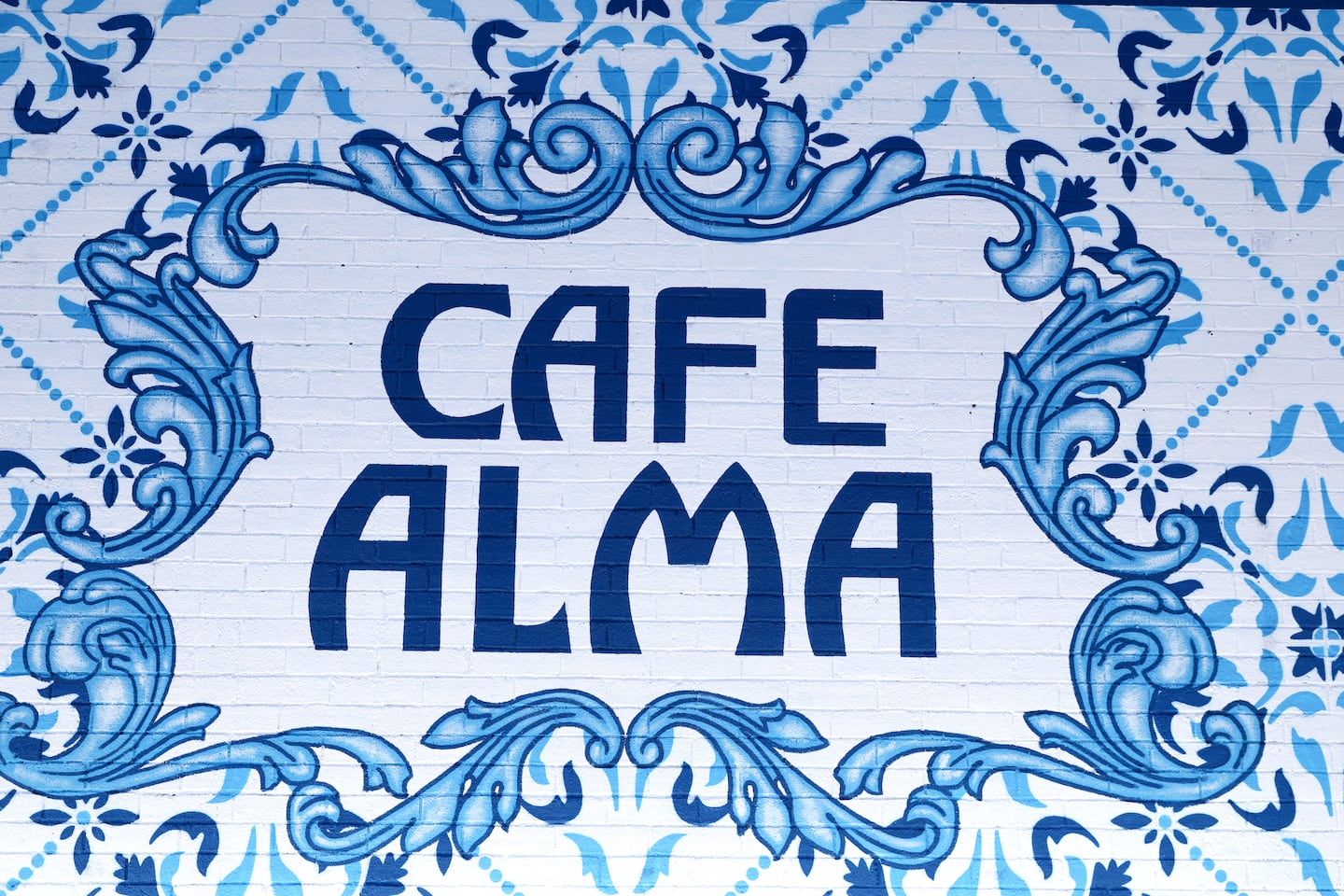 Cafe Alma's mural on the side of the building.