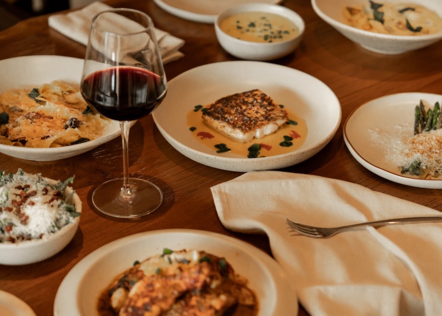 Spread of food and wine at Nusa By Suka restaurant in Ubud, Bali, Indonesia