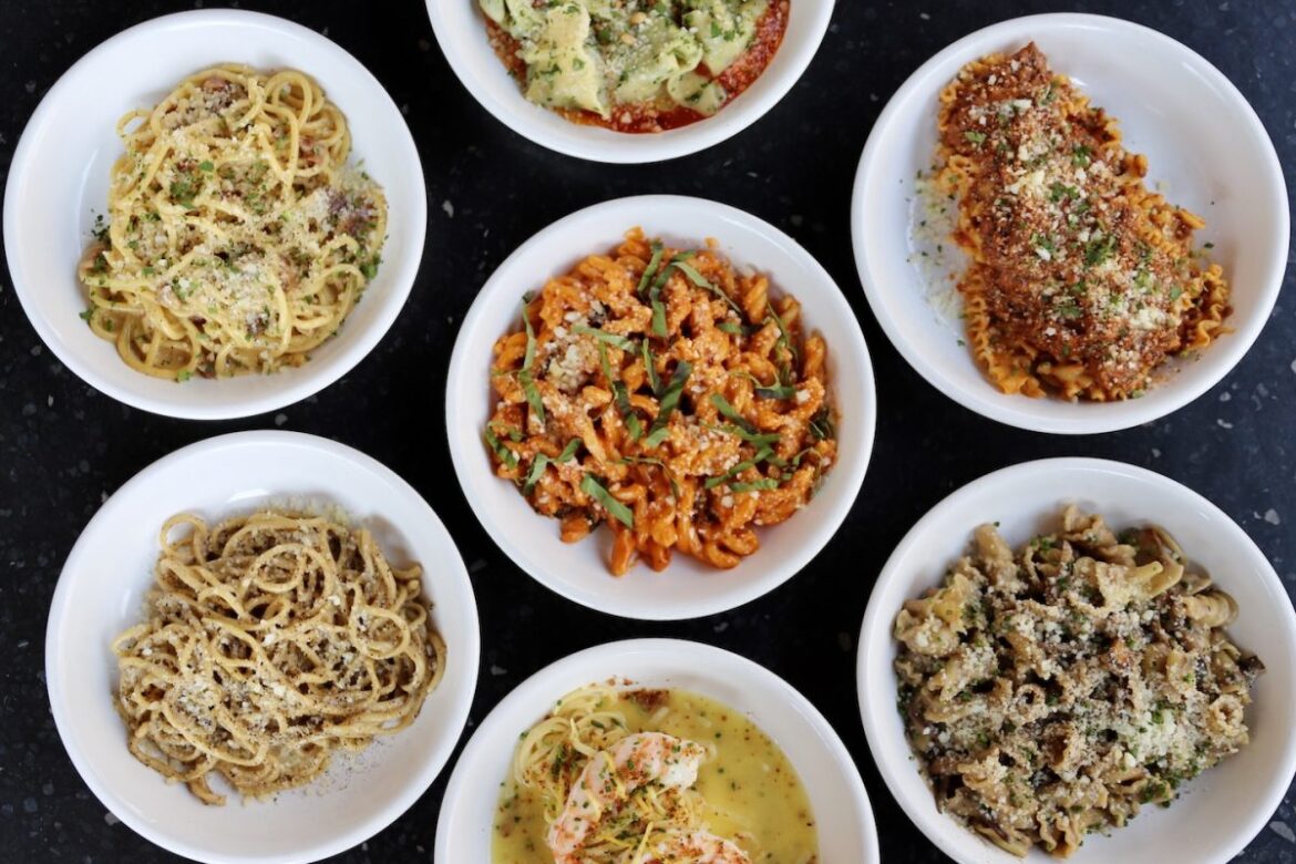 A table full of bowls of pasta.