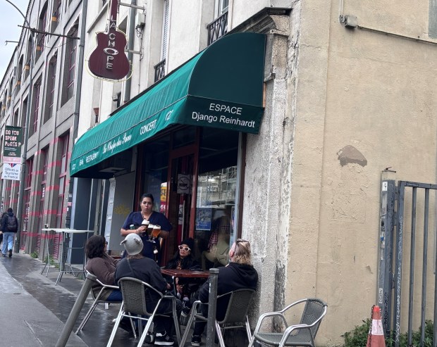 A guitar-shaped neon sign resides over the entry of La Chope des Puces, a temple of the Manouche jazz created by Django Reinhardt in the 1930s. Jazz aficionados from throughout the world make pilgrimages to this north Paris neighborhood devoted to flea markets. (Janet Podolak - For The News-Herald)