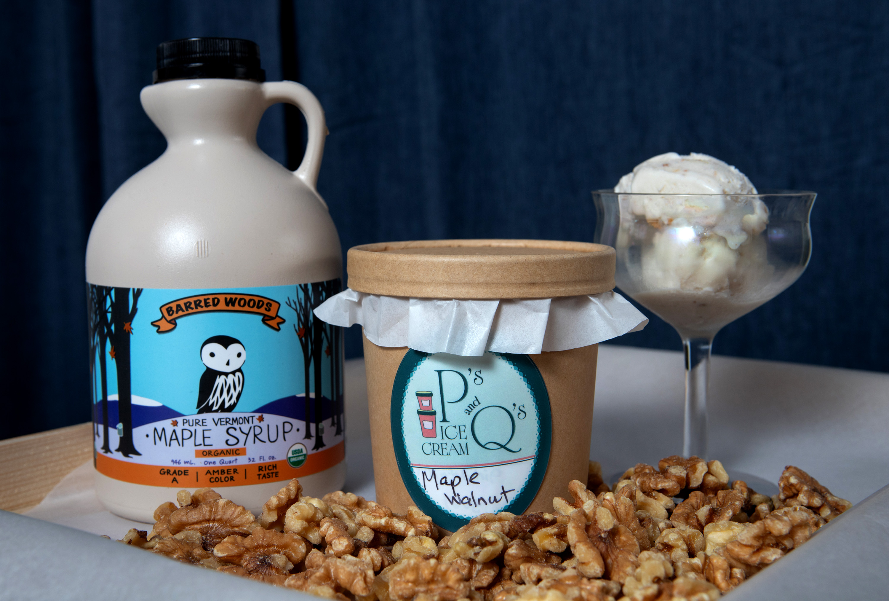 A pint of Maple Walnut Ice Cream is displayed with...