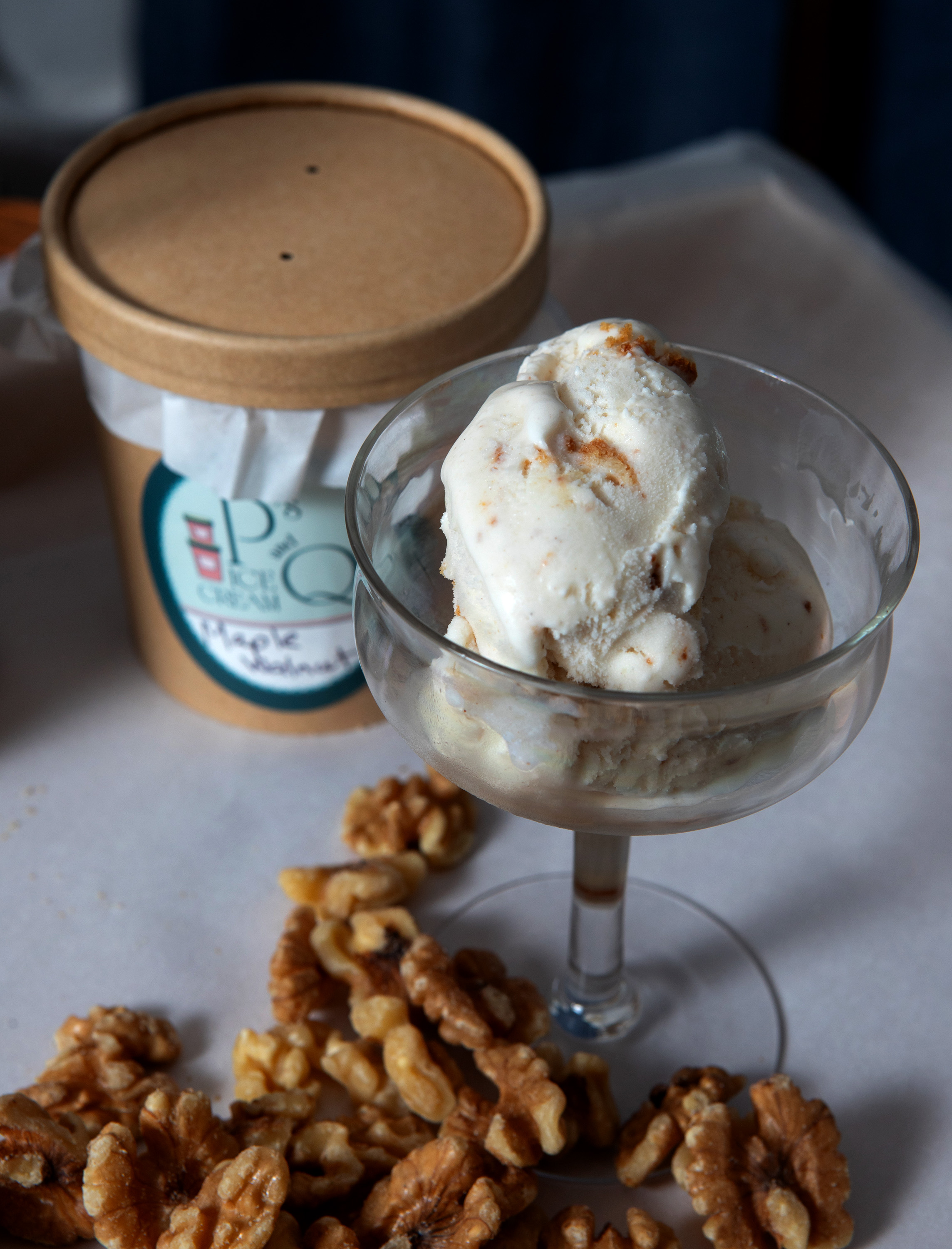 A dish of Maple Walnut Ice Cream is displayed with...