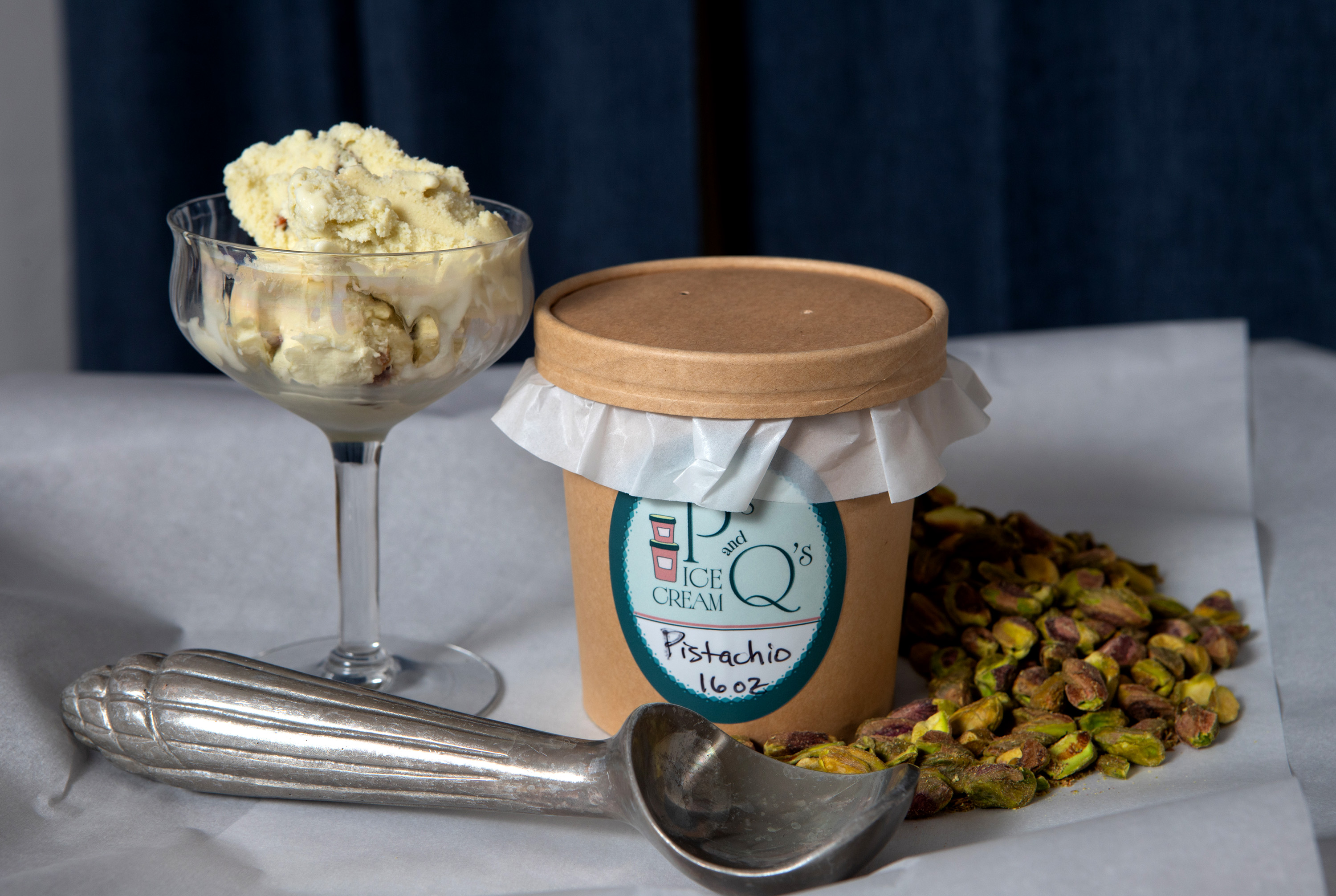 A pint of Pistachio Ice Cream is shown with pistachios...