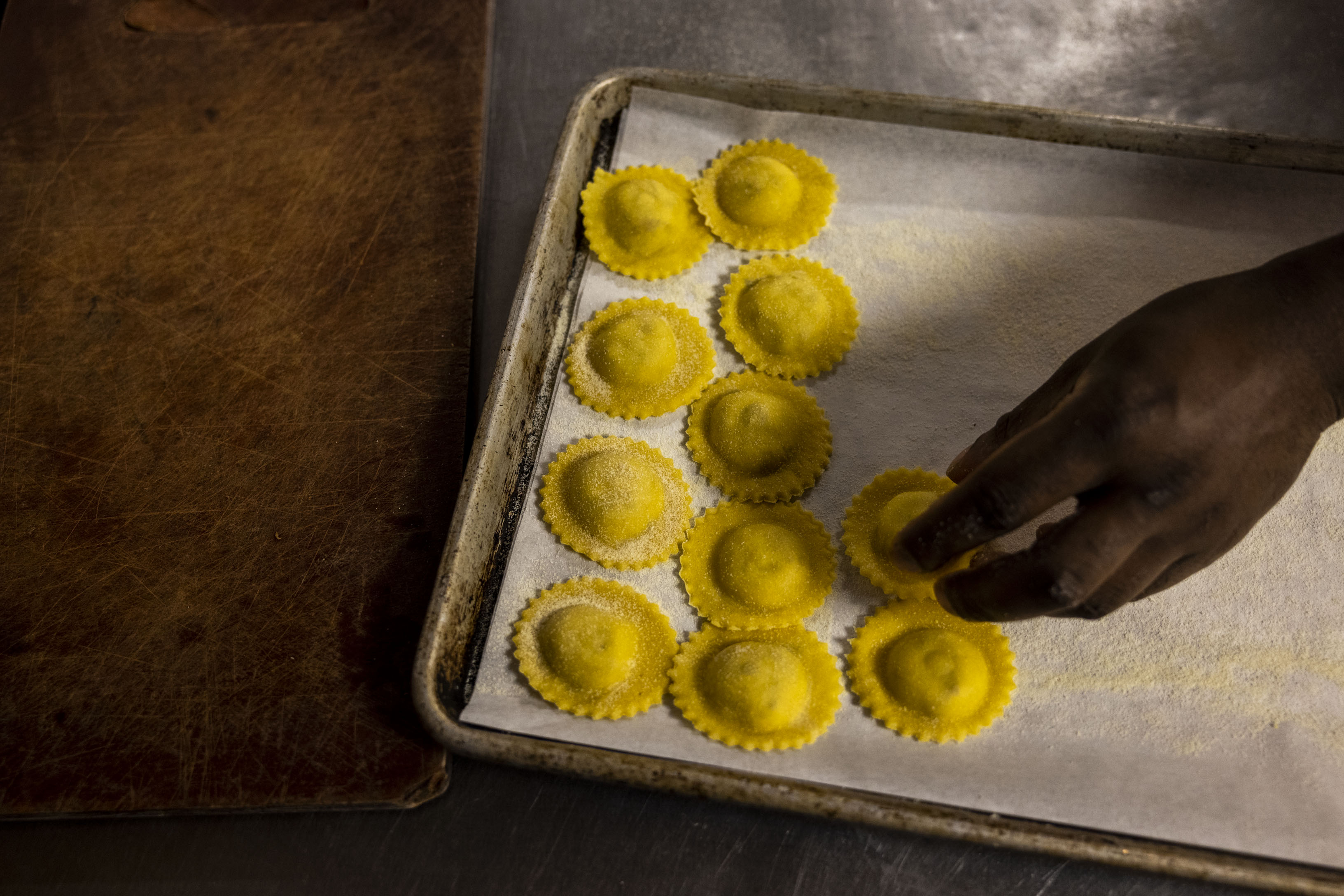 Chef Ty McDuffie places his duck confit ravioli onto a...