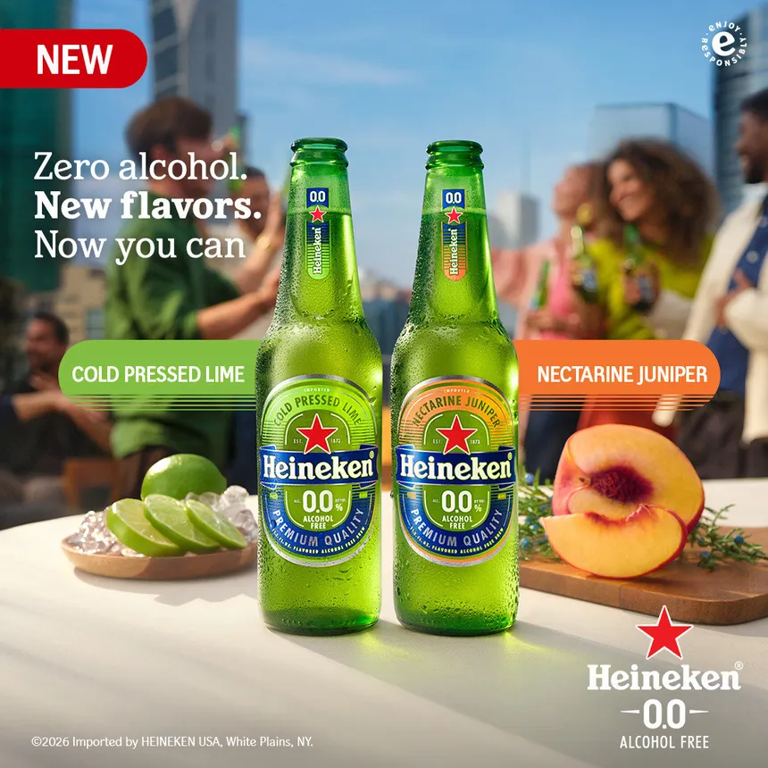 An ad for the new flavored Heineken 0.0 that shows people in the background and limes and nectarines next to the bottles.
