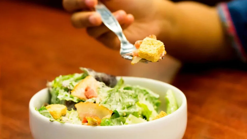 Caesar salad on table
