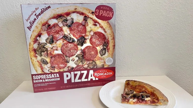 Pizza slice and packaging on the table