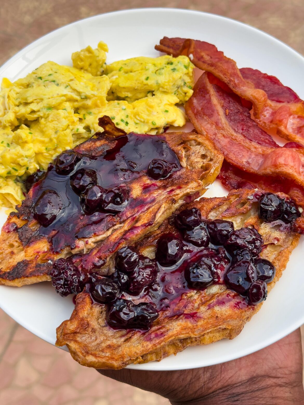 French toast croissant with mixed berry compote, cheese eggs and bacon