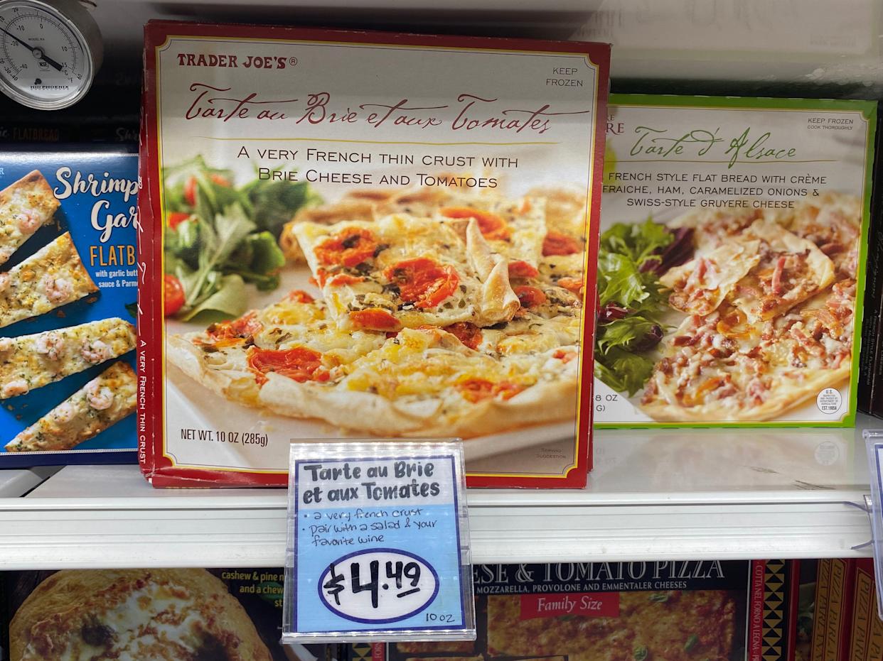brie and tomato pizza in the freezer aisle at trader joes