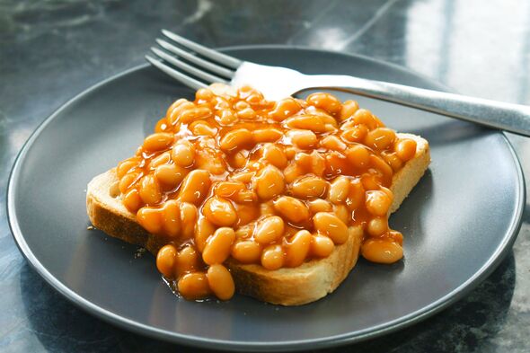 Beans on toast with fork on a plate.