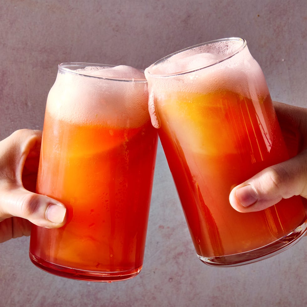 campari and beer in a tall glass with an orange wedge