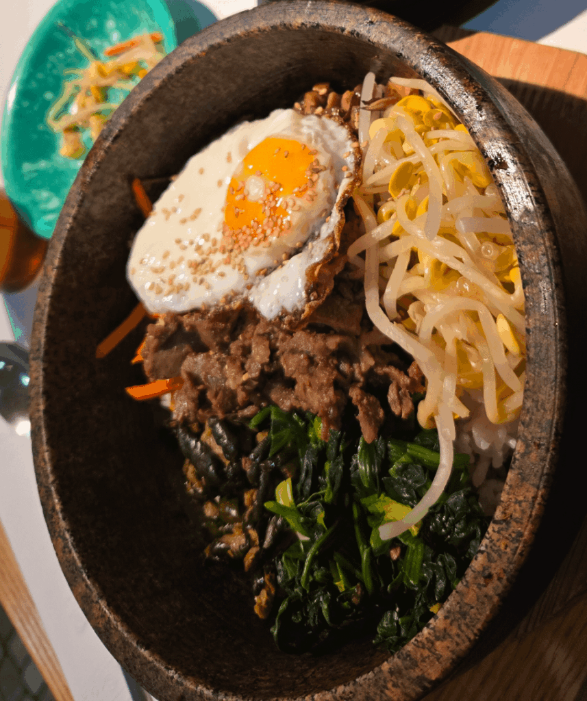 Stone Bowl Bibimbop with a sunny side up egg slightly runny.
