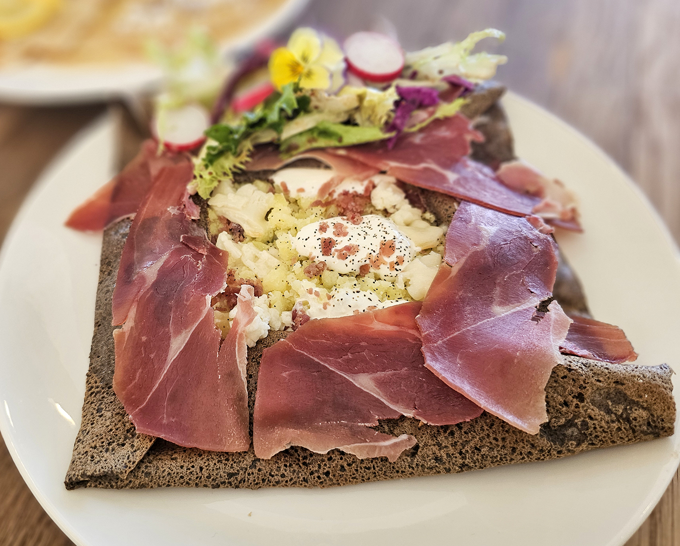 Savoyarde crepe with raclette, generous ribbons of prosciutto and a dollop of sour cream. (Heather Irwin/The Press Democrat)